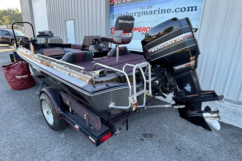 Slide: The Image of 1988 Ranger 375V boat with Mercury XR2 engine on trailer, parked outside. - 13
