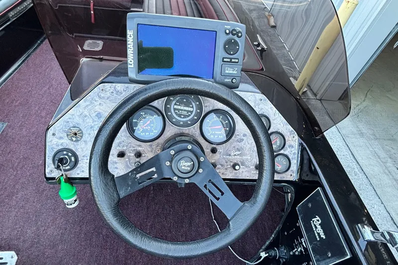 Slide: The Image of Dashboard of a 1988 Ranger 375V boat with steering wheel and navigation instruments. - 8