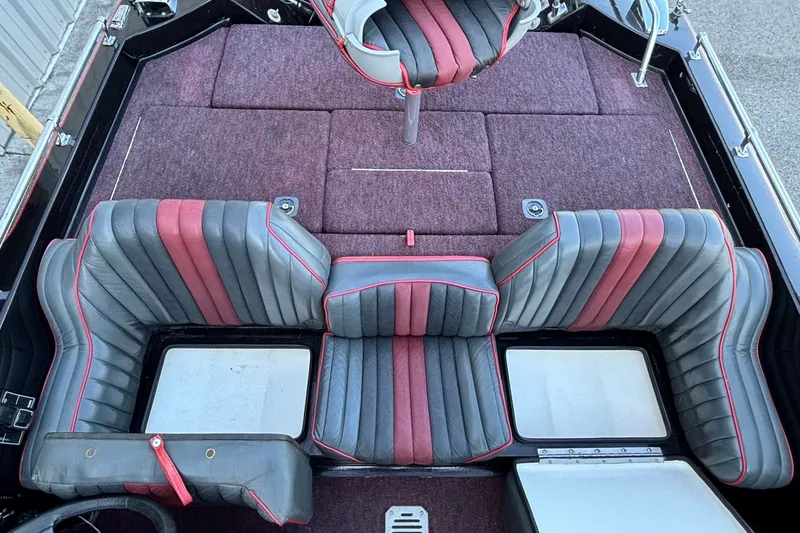 Slide: The Image of 1988 Ranger 375V boat interior with red and gray seating, carpeted deck. - 10