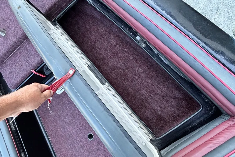 Slide: The Image of 1988 Ranger 375V boat interior with maroon carpet and storage compartment. - 5