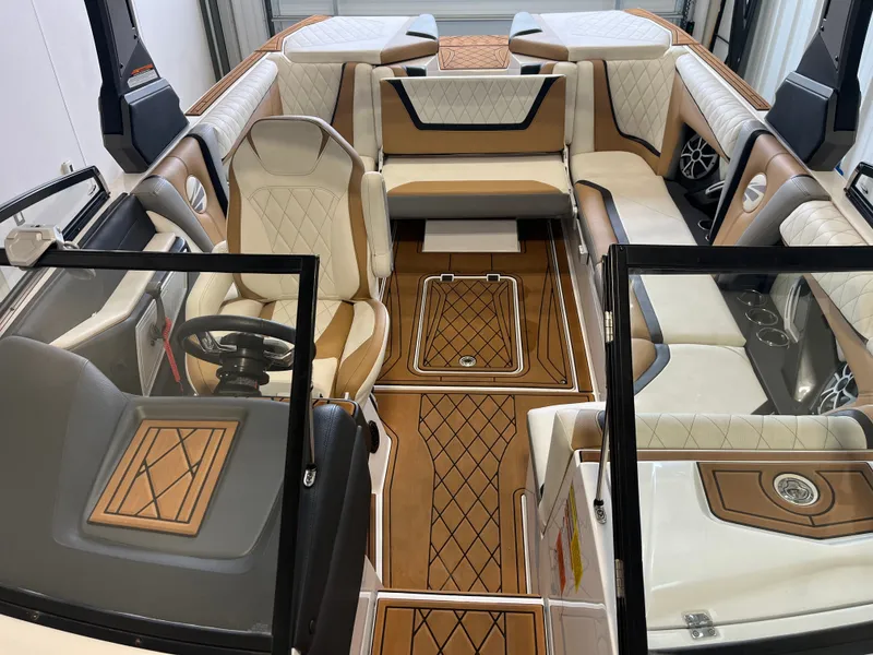 Slide: The Image of Interior of a 2018 Tigé 23RZX with luxurious seating and sleek wood flooring. - 17