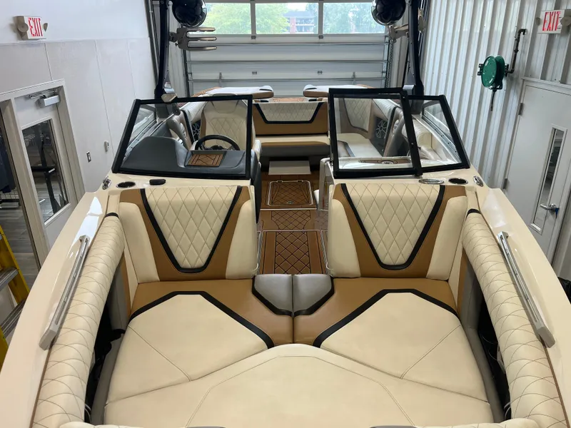 Slide: The Image of Interior view of a 2018 Tigé 23RZX with sleek cream and brown upholstery. - 23