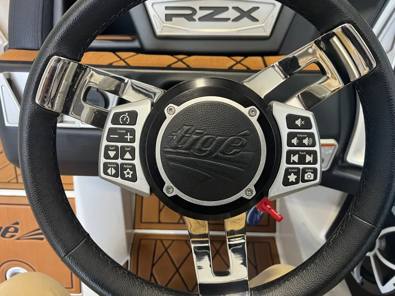 Slide: The Image of Close-up of a steering wheel with Tigé logo and control buttons. - 19
