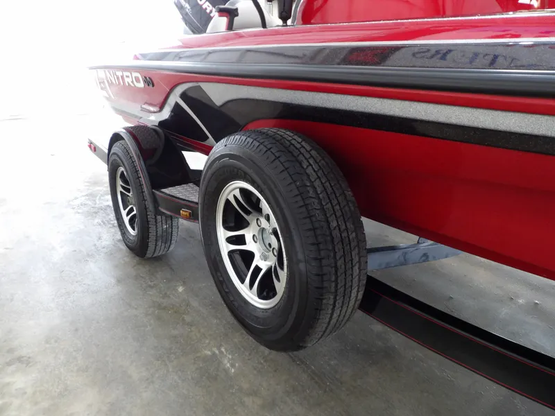 Slide: The Image of A red 2010 Nitro Z-7 boat on a trailer with black rims. - 23