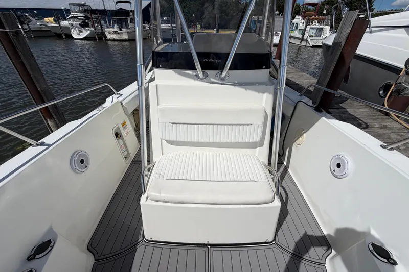 Slide: The Image of 1999 Boston Whaler 26 Outrage boat interior with seating and docked at marina. - 45