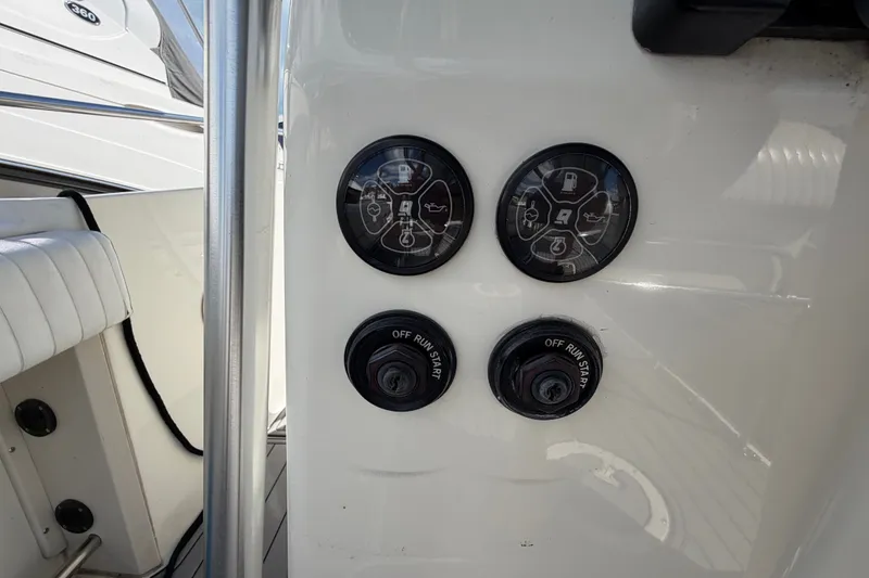 Slide: The Image of Control panel of a 1999 Boston Whaler 26 Outrage boat with gauges and switches. - 25