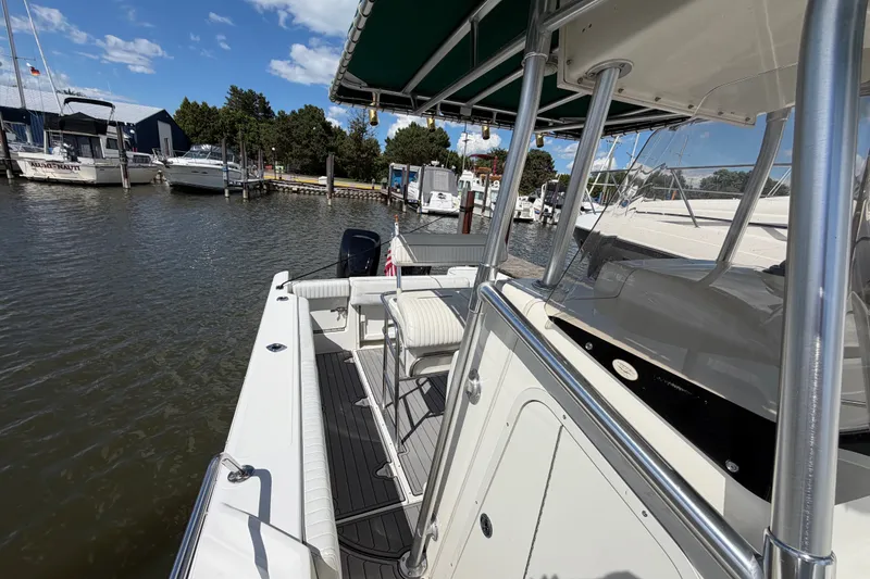Slide: The Image of 1999 Boston Whaler 26 Outrage docked at marina under clear blue sky. - 31