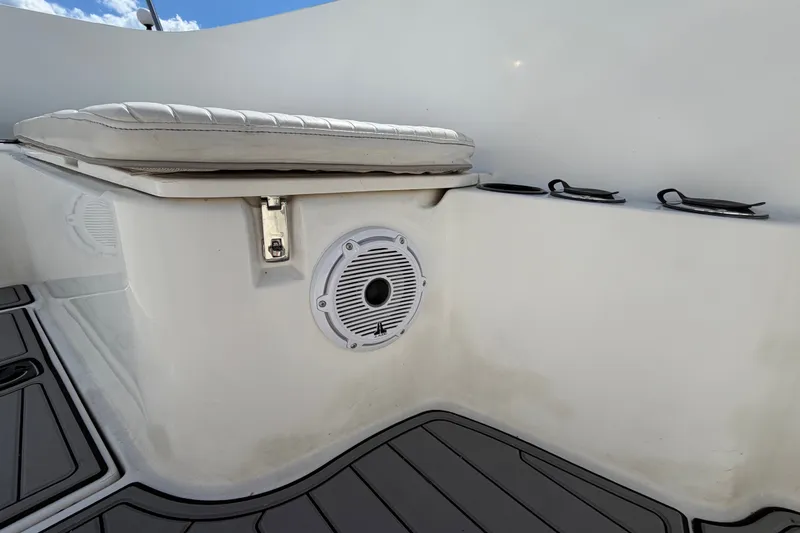 Slide: The Image of 1999 Boston Whaler 26 Outrage interior with cushioned seating and speaker detail. - 44