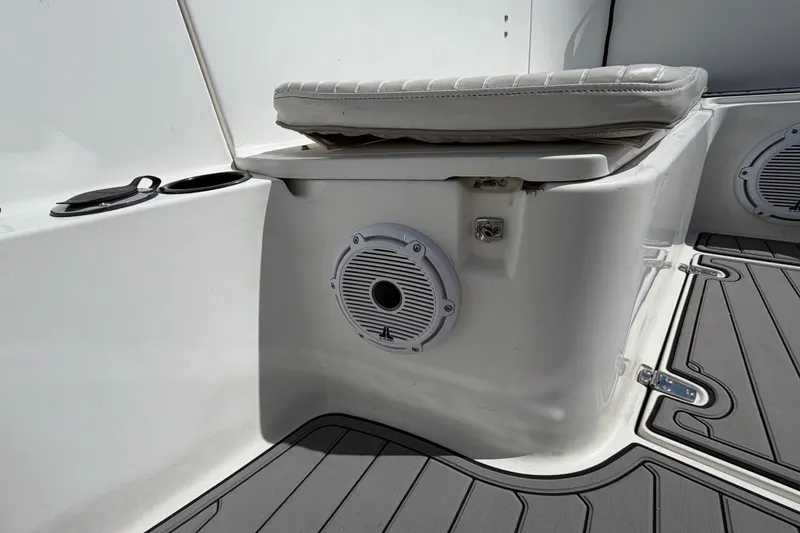Slide: The Image of 1999 Boston Whaler 26 Outrage boat interior with speaker and cushioned seat. - 38