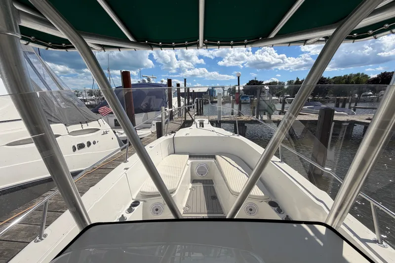 Slide: The Image of 1999 Boston Whaler 26 Outrage boat docked at marina under clear blue sky. - 28