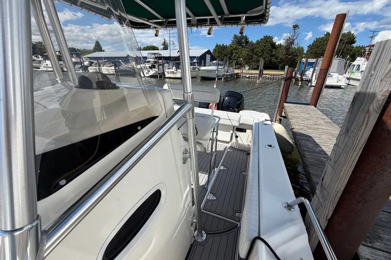 Slide: The Image of 1999 Boston Whaler 26 Outrage docked at marina, featuring sleek design and spacious deck. - 30