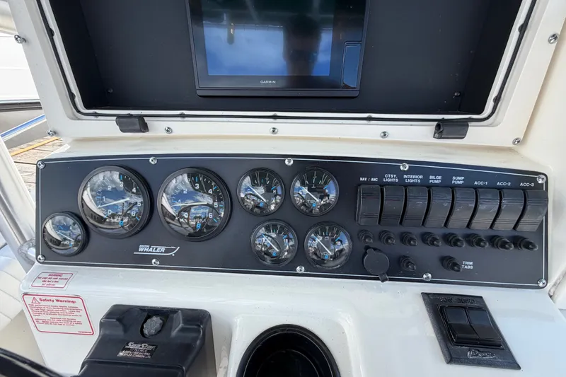 Slide: The Image of Dashboard of a 1999 Boston Whaler 26 Outrage boat with gauges and controls. - 27