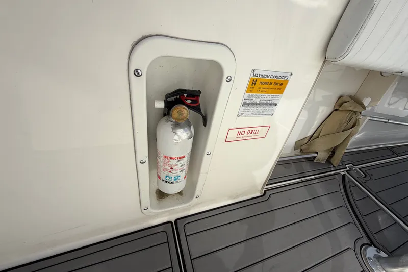 Slide: The Image of Fire extinguisher on 1999 Boston Whaler 26 Outrage boat with capacity label. - 35