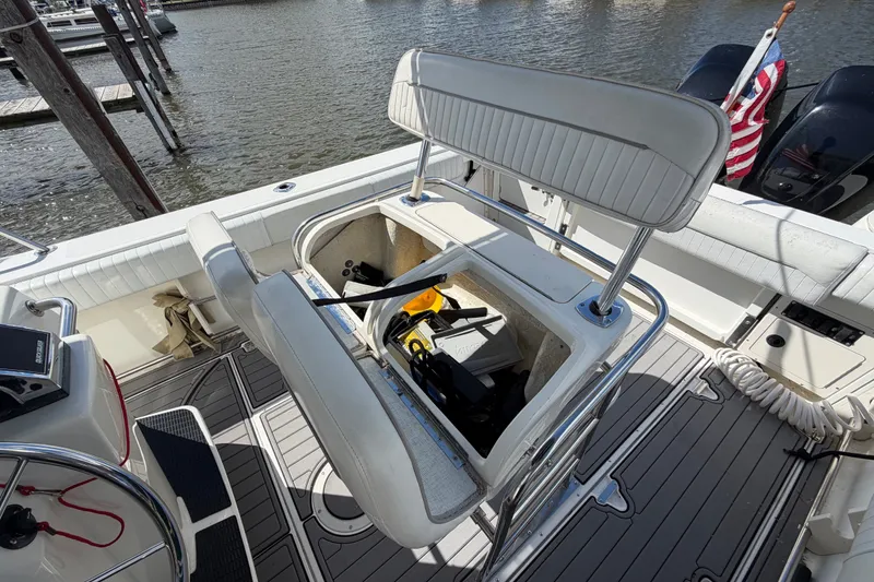 Slide: The Image of 1999 Boston Whaler 26 Outrage boat interior with open storage compartment and seating. - 21