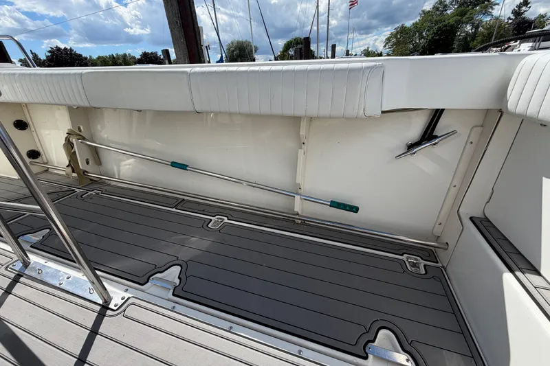 Slide: The Image of 1999 Boston Whaler 26 Outrage boat interior with cushioned seating and deck details. - 19