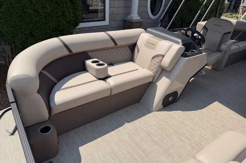 Slide: The Image of Luxurious seating on 2025 Crest Classic 200 pontoon boat with cup holders and elegant design. - 5