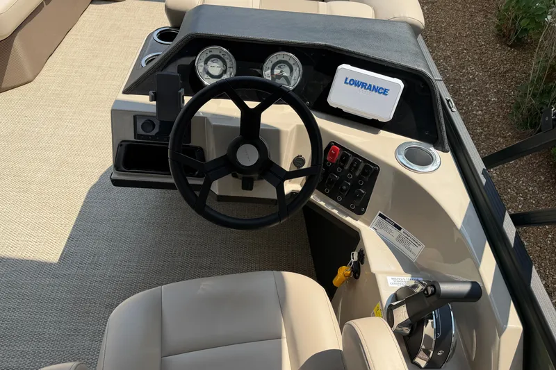 Slide: The Image of 2025 Crest Classic 200 boat dashboard with steering wheel and control panel. - 12