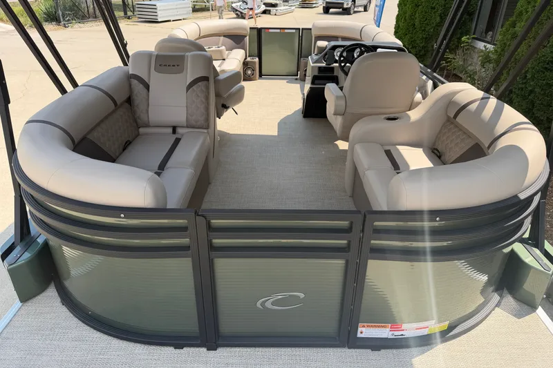 Slide: The Image of 2025 Crest Classic 200 pontoon boat with beige seating and modern design. - 14