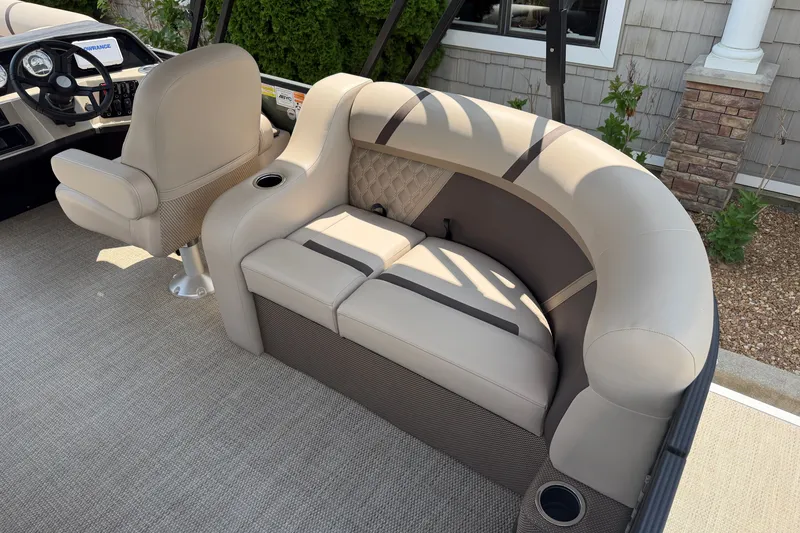 Slide: The Image of Luxurious seating on 2025 Crest Classic 200 boat, featuring beige upholstery and cup holders. - 15
