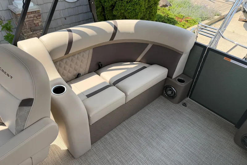 Slide: The Image of Luxurious seating on 2025 Crest Classic 200 pontoon boat with cup holders and speakers. - 11