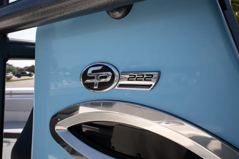 Slide: The Image of 2027 Sea Pro 222 Center Console boat emblem on a light blue surface. - 16