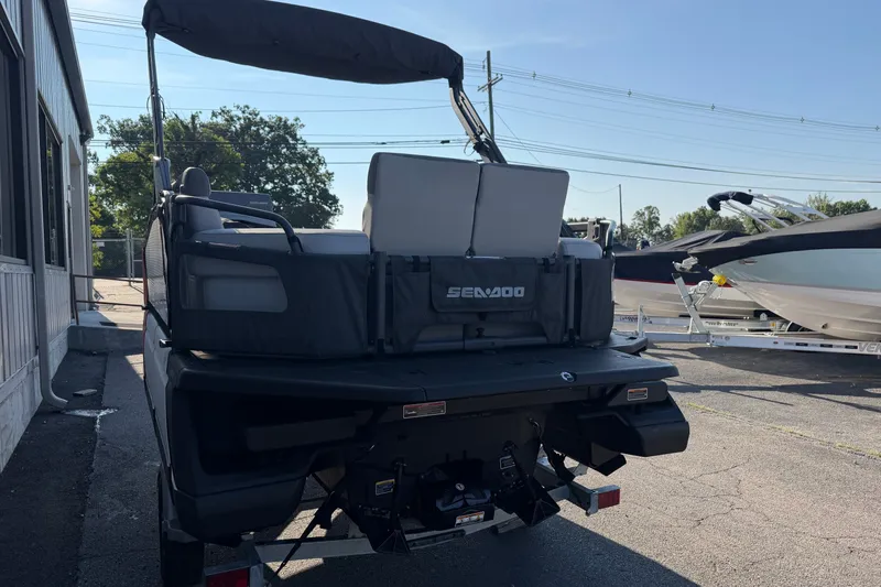 Slide: The Image of 2024 Sea-Doo Switch Compact parked outdoors, rear view with cover and trailer. - 14