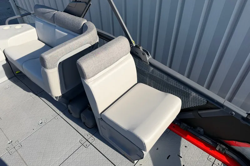Slide: The Image of 2024 Sea-Doo Switch Compact interior seating with gray upholstery and textured flooring. - 15