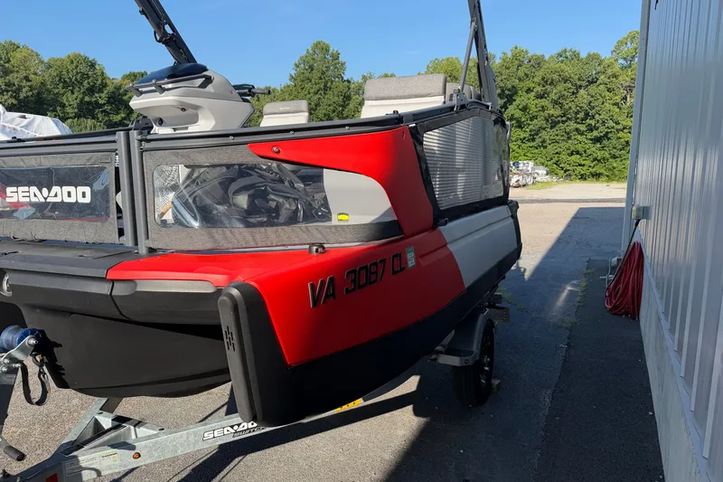 Slide: The Image of 2024 Sea-Doo Switch Compact in red, parked on a trailer, side view. - 17