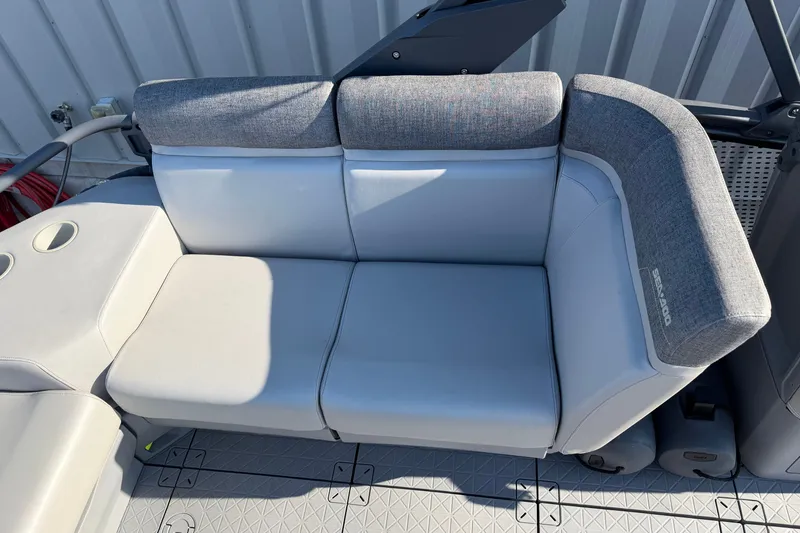 Slide: The Image of 2024 Sea-Doo Switch Compact boat seat with gray upholstery and cup holders. - 7
