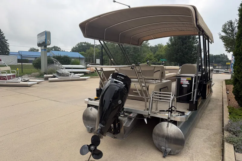 Slide: The Image of 2023 Crest Classic LX 240 SLSC pontoon boat with canopy and outboard motor in a dealership lot. - 19