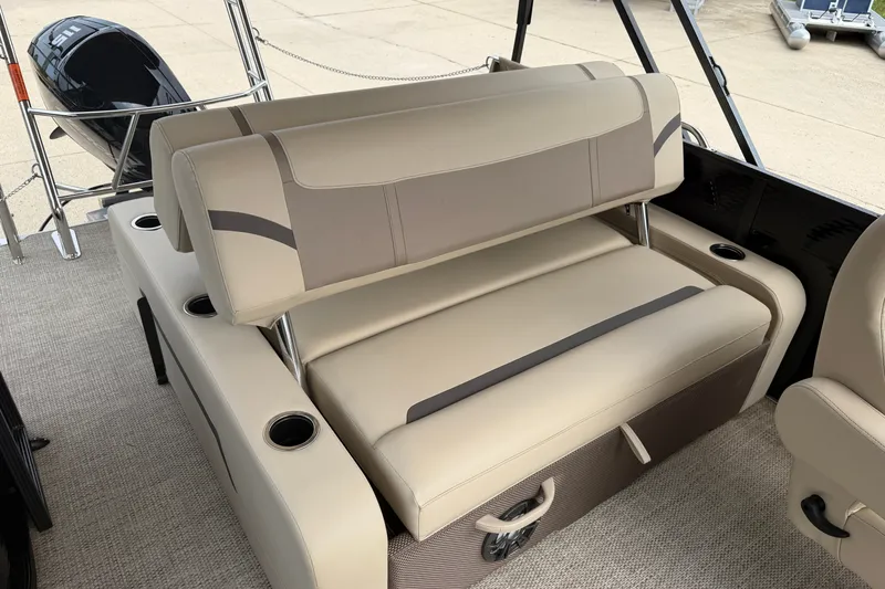 Slide: The Image of 2023 Crest Classic LX 240 SLSC boat interior with beige seating and cup holders. - 14