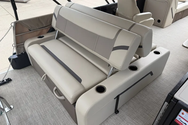 Slide: The Image of 2023 Crest Classic LX 240 SLSC boat interior with beige seating and cup holders. - 15