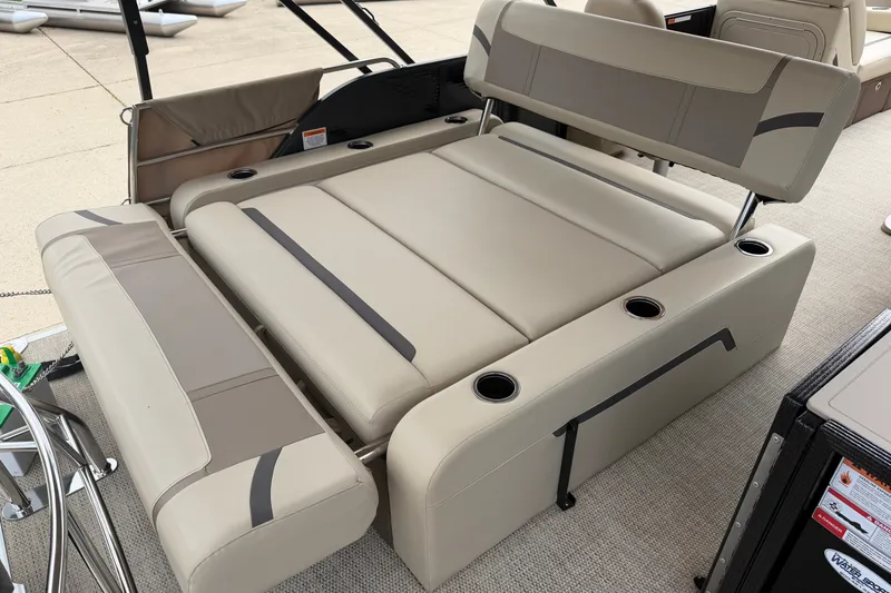 Slide: The Image of 2023 Crest Classic LX 240 SLSC boat interior with beige seating and cup holders. - 16