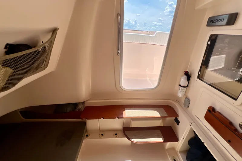 Slide: The Image of Interior of 2013 Grady-White Canyon 336 boat, featuring seating and storage. - 33