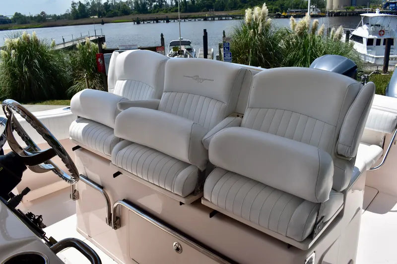 Slide: The Image of 2013 Grady-White Canyon 336 boat seats, luxurious white leather, docked by a scenic waterfront. - 54