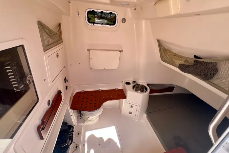 Slide: The Image of 2013 Grady-White Canyon 336 cabin interior with seating, storage, and sink. - 36