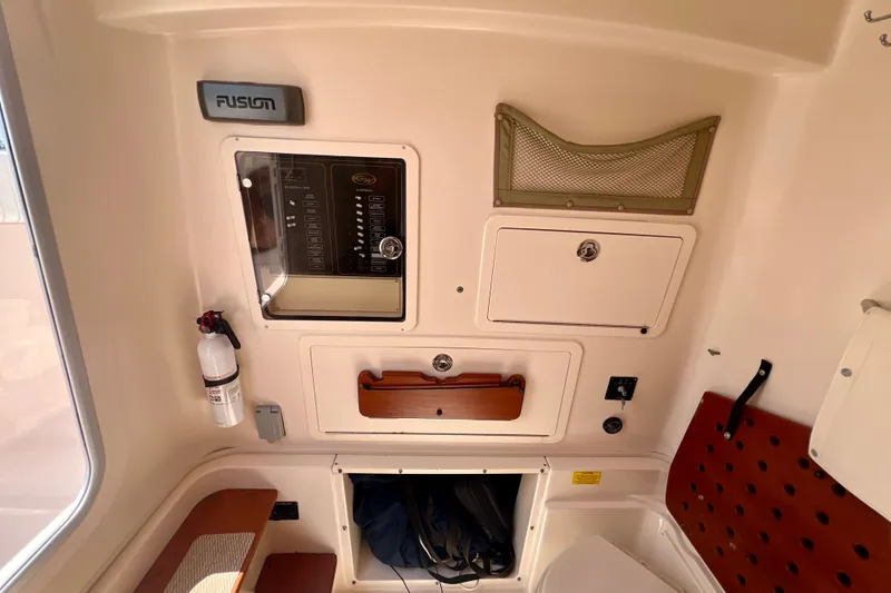 Slide: The Image of Interior of a 2013 Grady-White Canyon 336 boat with storage compartments and control panel. - 35