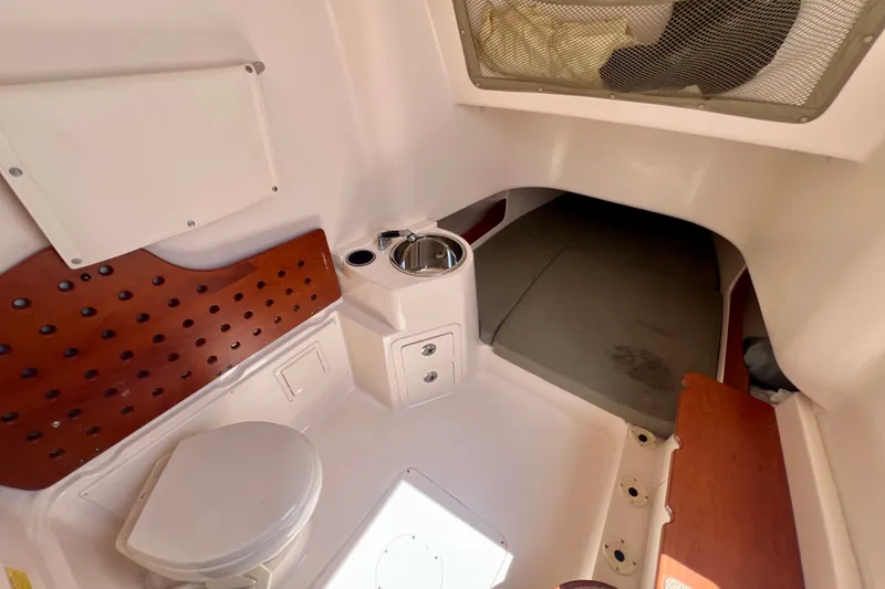 Slide: The Image of 2013 Grady-White Canyon 336 boat interior with toilet and sink. - 30