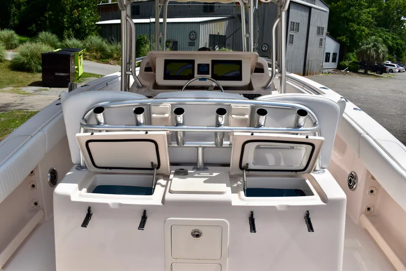 Slide: The Image of 2013 Grady-White Canyon 336 boat interior with fishing rod holders and storage compartments. - 76