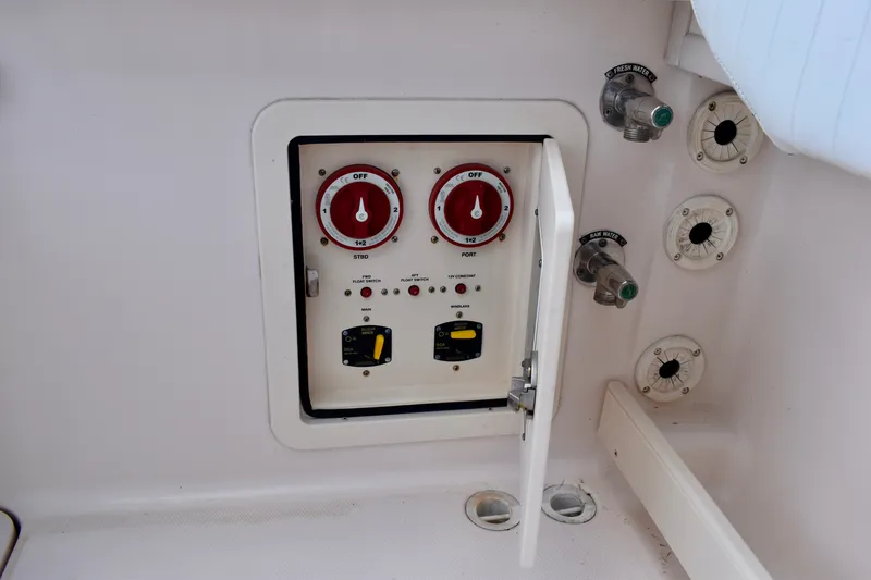Slide: The Image of Control panel on a 2013 Grady-White Canyon 336 boat, featuring switches and valves. - 23