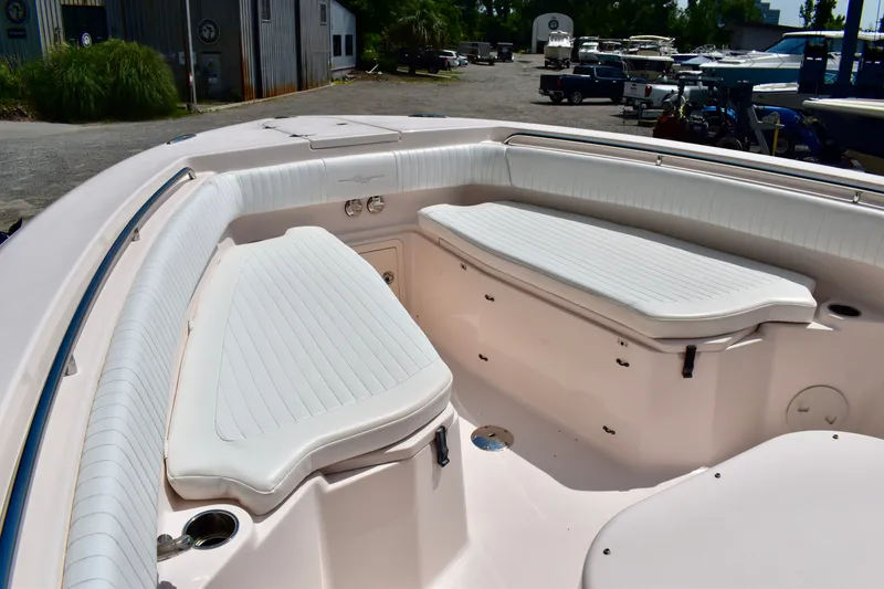 Slide: The Image of 2013 Grady-White Canyon 336 boat interior with white cushioned seating. - 68