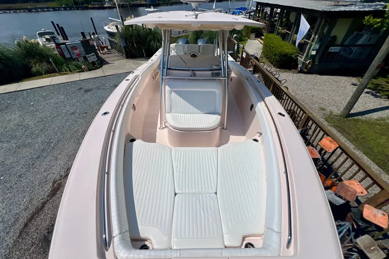 Slide: The Image of 2013 Grady-White Canyon 336 boat with spacious seating, docked near a marina. - 29