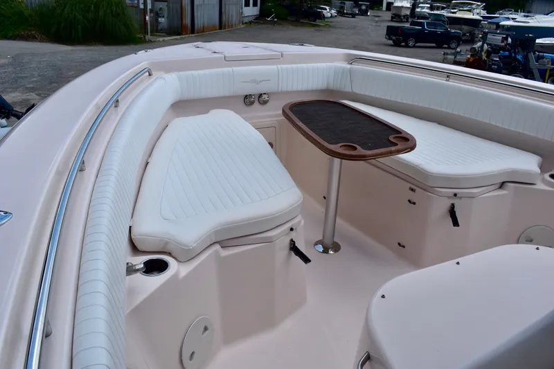 Slide: The Image of 2013 Grady-White Canyon 336 boat interior with cushioned seating and table. - 22