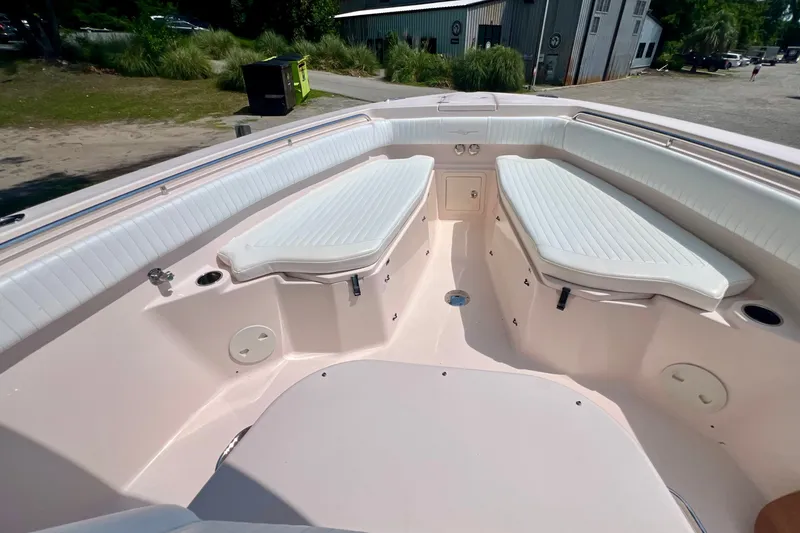 Slide: The Image of 2013 Grady-White Canyon 336 boat interior with cushioned seating and storage compartments. - 38