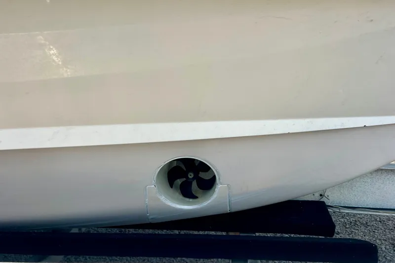 Slide: The Image of 2013 Grady-White Canyon 336 boat hull with visible thruster detail. - 47