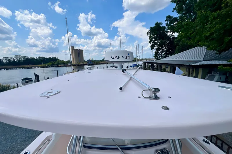 Slide: The Image of 2013 Grady-White Canyon 336 boat docked, featuring Garmin equipment, under a partly cloudy sky. - 45