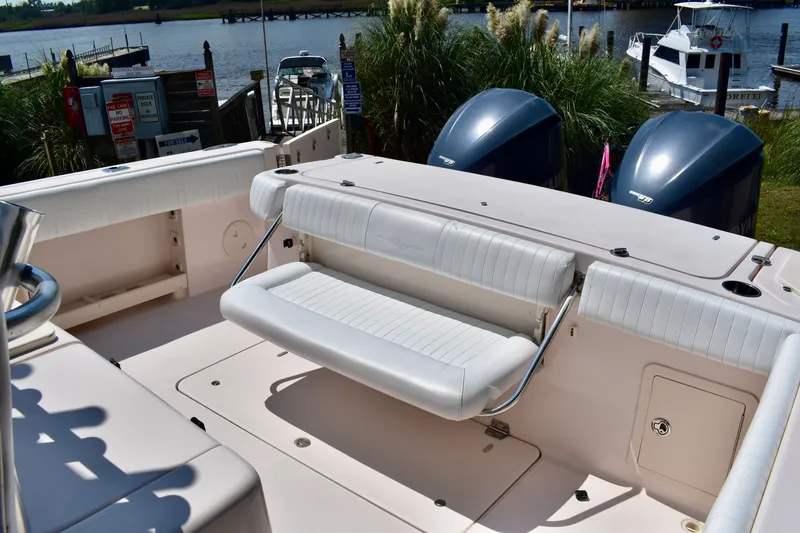 Slide: The Image of 2013 Grady-White Canyon 336 boat with seating, docked by a scenic waterfront. - 53