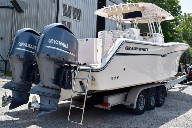 Slide: The Image of 2013 Grady-White Canyon 336 boat with twin Yamaha engines on a trailer. - 14
