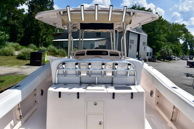 Slide: The Image of 2013 Grady-White Canyon 336 boat interior with rod holders and helm station. - 17