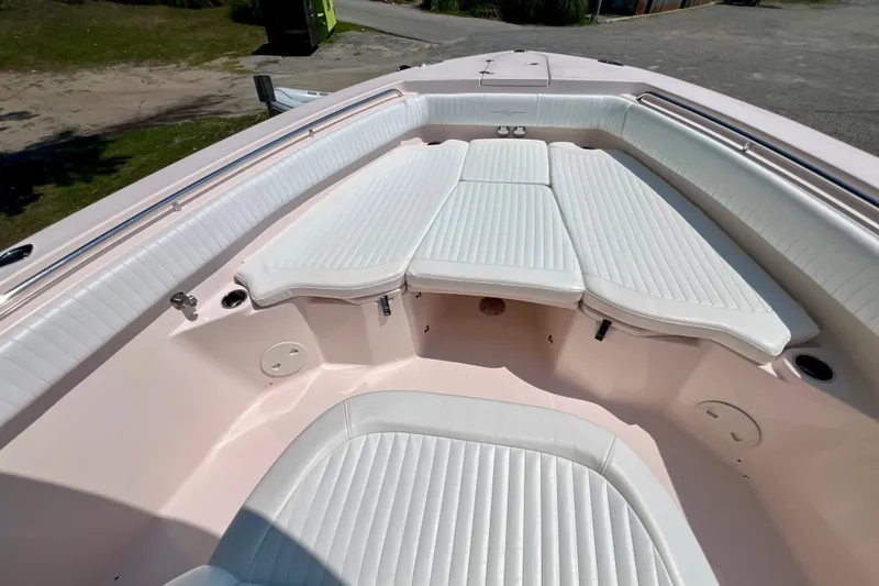 Slide: The Image of 2013 Grady-White Canyon 336 boat interior with white cushioned seating. - 28
